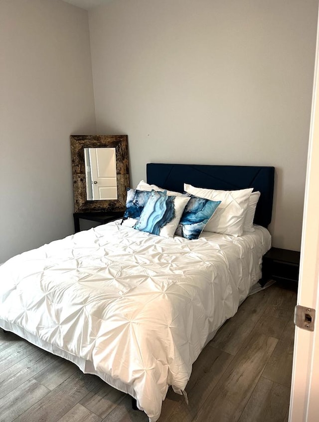 bedroom with wood finished floors