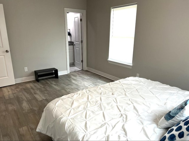 bedroom with baseboards and wood finished floors