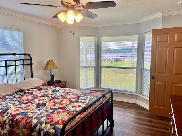 bedroom with multiple windows, ornamental molding, ceiling fan, and dark wood-type flooring