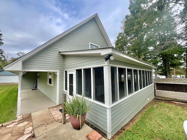 back of property with a sunroom