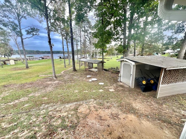 view of yard featuring an outbuilding and a water view