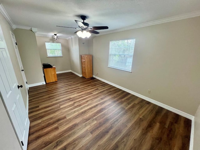 unfurnished bedroom with multiple windows, ceiling fan, dark wood-type flooring, and ornamental molding