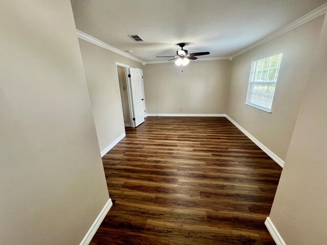 unfurnished room featuring ceiling fan, dark hardwood / wood-style flooring, and crown molding