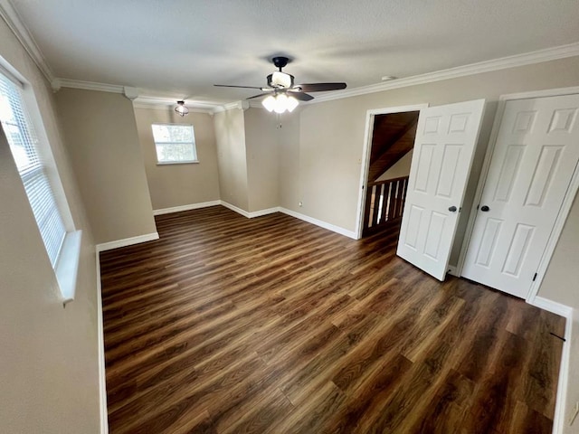 unfurnished room featuring dark hardwood / wood-style floors, ceiling fan, and crown molding