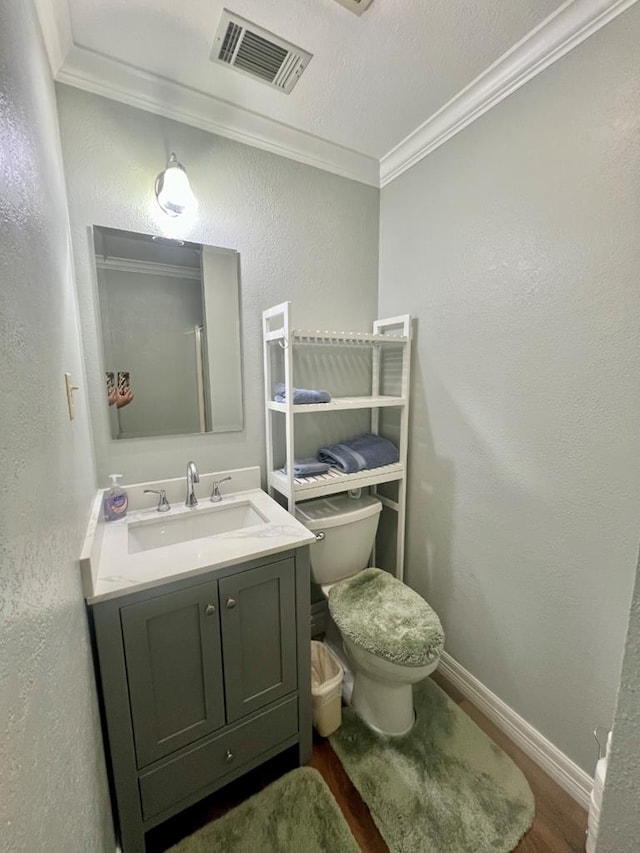 419 Pinemont Dr, Hemphill, TX 75948 - bathroom with ornamental molding, vanity, toilet, wood finished floors, and baseboards