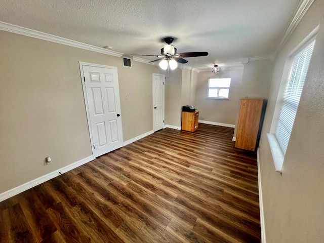 419 Pinemont Dr, Hemphill, TX 75948 - unfurnished bedroom with crown molding, dark wood-style flooring, baseboards, ceiling fan, and a textured ceiling