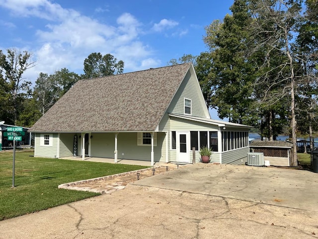 419 Pinemont Dr, Hemphill, TX 75948 - view of front of property featuring concrete driveway, roof with shingles, central AC, a sunroom, and a front lawn