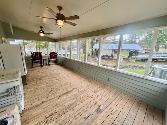 unfurnished sunroom with ceiling fan and vaulted ceiling