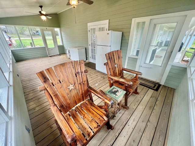 sunroom / solarium with ceiling fan and vaulted ceiling