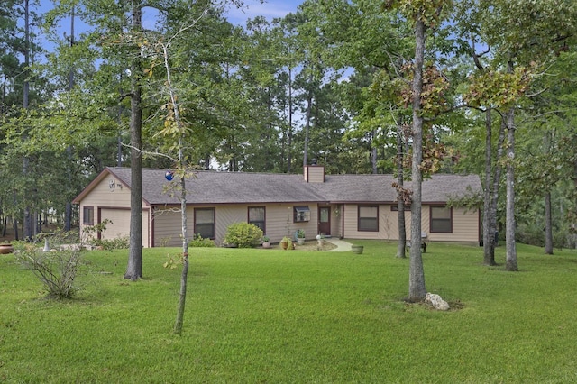 ranch-style home featuring a garage and a front yard