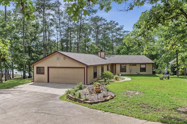 single story home featuring a garage and a front lawn