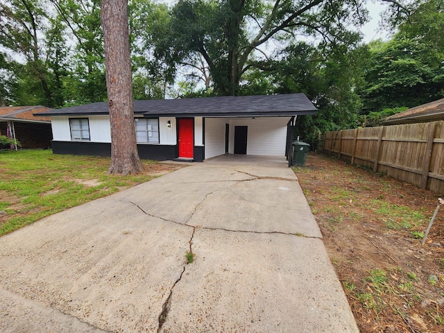 view of front facade with a front yard and a carport