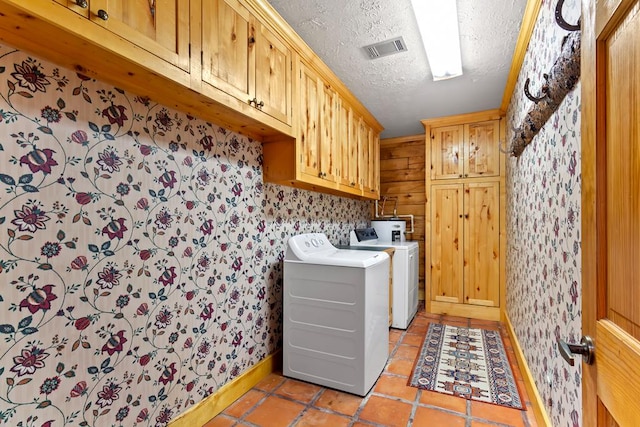194 Woodsedge Dr, Brookeland, TX 75931 - laundry area featuring cabinet space, washing machine and dryer, wallpapered walls, a textured ceiling, and light tile patterned floors
