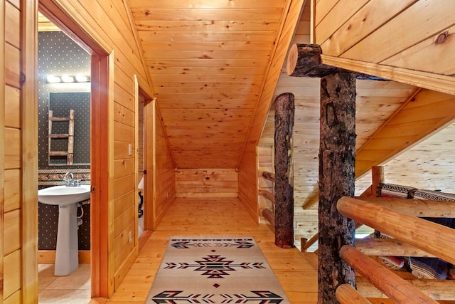 194 Woodsedge Dr, Brookeland, TX 75931 - corridor featuring wood walls, light wood-style floors, wooden ceiling, and lofted ceiling