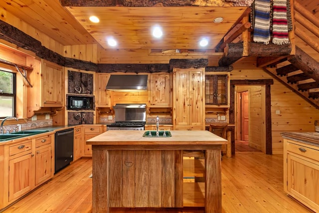 kitchen with sink, black appliances, wall chimney range hood, and light hardwood / wood-style floors