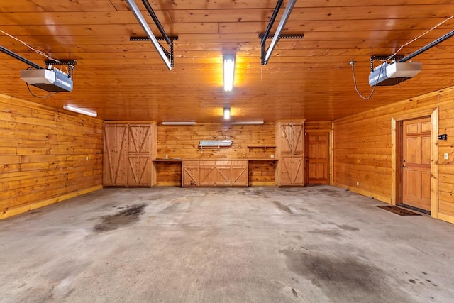 garage with wood ceiling, wooden walls, and a garage door opener