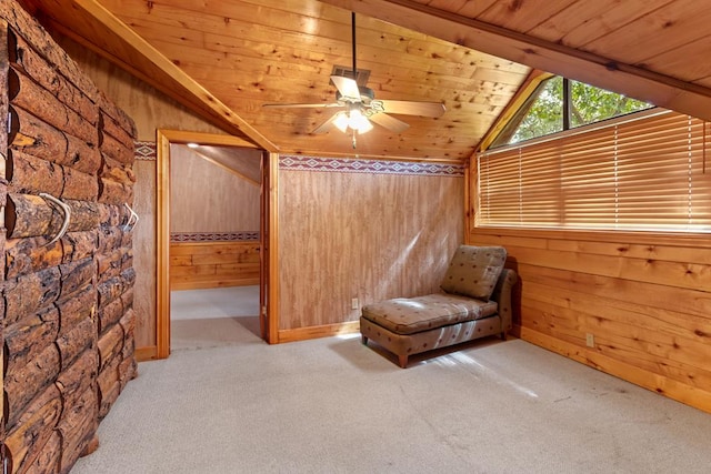 unfurnished room with light carpet, wooden ceiling, ceiling fan, and wooden walls