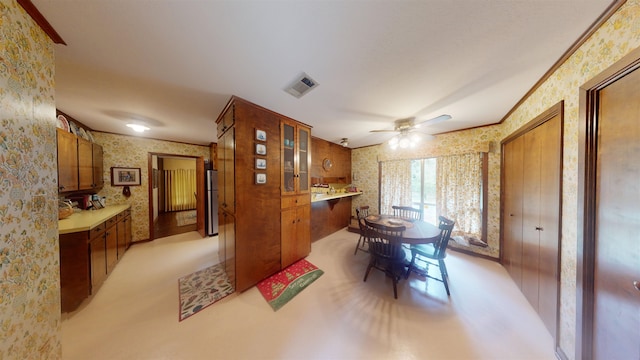 carpeted dining space featuring ceiling fan