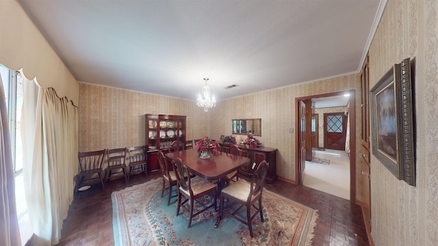 dining space with a chandelier, a healthy amount of sunlight, and ornamental molding