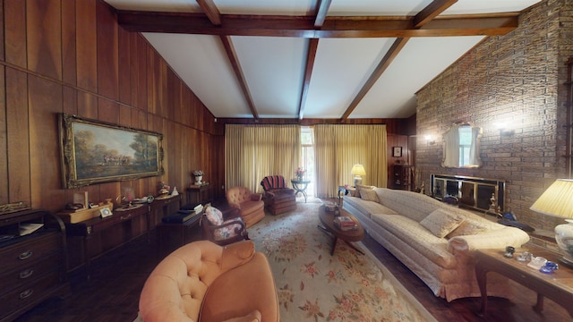 living room featuring lofted ceiling with beams, a brick fireplace, and wood walls