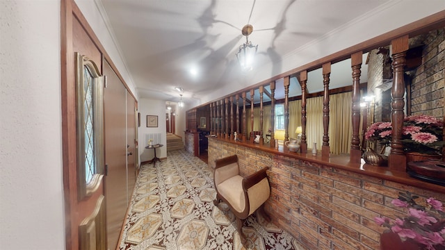 bar featuring crown molding and brick wall