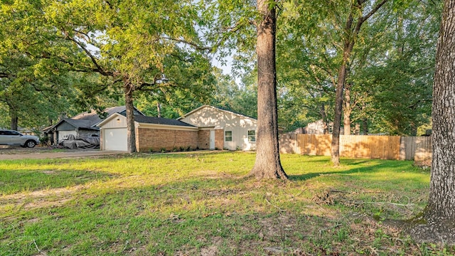 view of yard with an attached garage and driveway