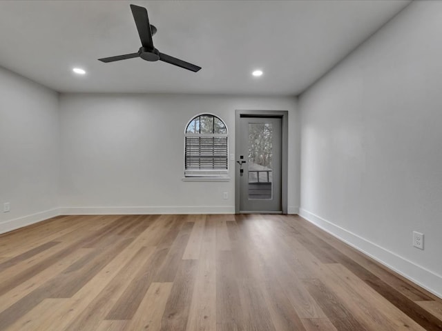 spare room with ceiling fan and light hardwood / wood-style floors