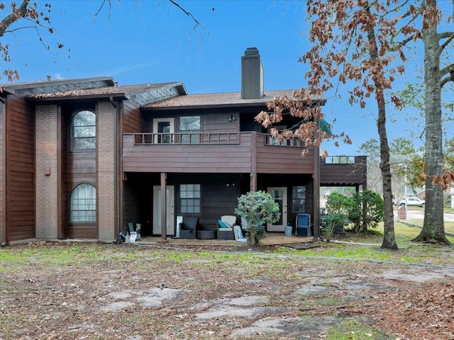 back of house featuring a balcony