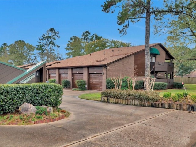 view of front facade with a garage and a balcony