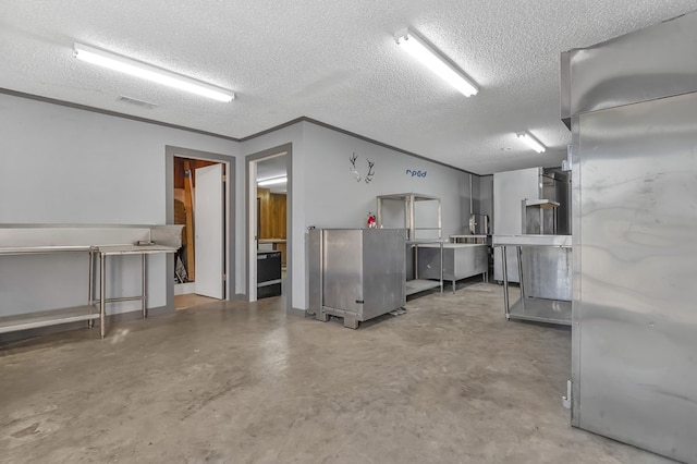 kitchen featuring a textured ceiling and concrete floors