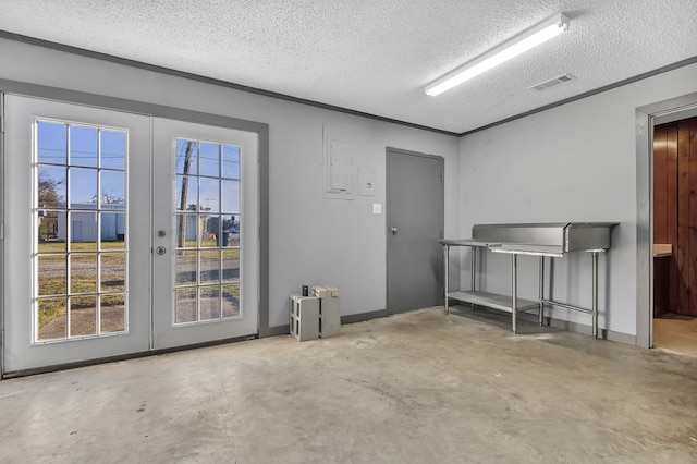 interior space with french doors and a textured ceiling