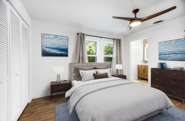 bedroom featuring a closet, ensuite bath, visible vents, and light wood-type flooring