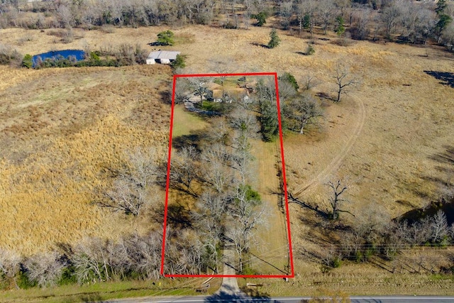 birds eye view of property with a rural view