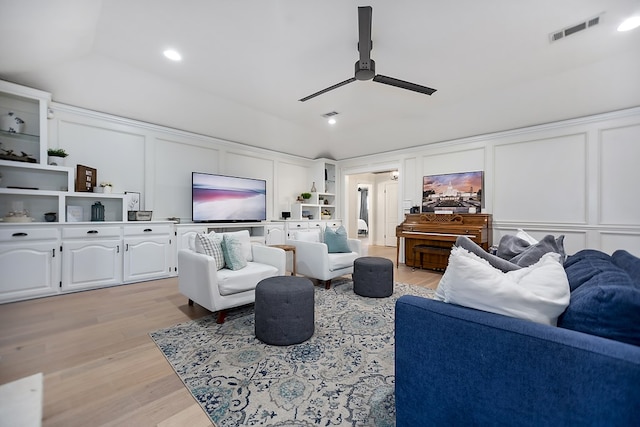 living room with vaulted ceiling, light hardwood / wood-style floors, and ceiling fan