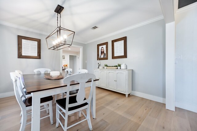 dining area featuring ornamental molding and light hardwood / wood-style floors