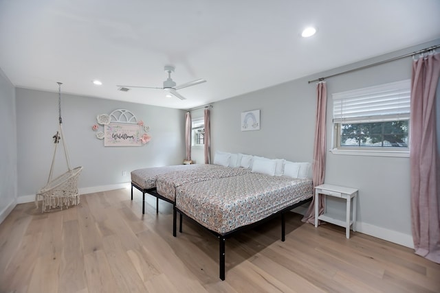 bedroom with ceiling fan and light hardwood / wood-style floors