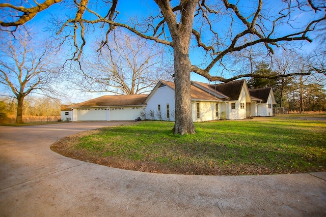 view of home's exterior featuring a garage and a lawn