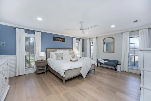 bedroom featuring crown molding, light hardwood / wood-style floors, and ceiling fan