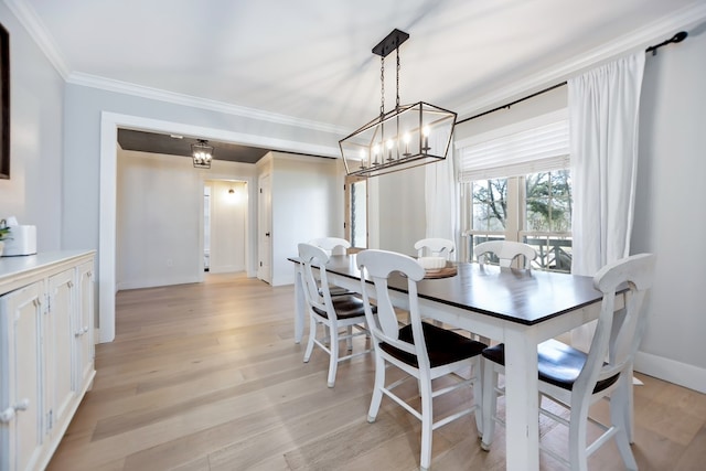 dining area featuring crown molding and light hardwood / wood-style floors