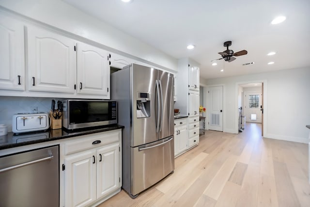 kitchen with white cabinetry, tasteful backsplash, light hardwood / wood-style flooring, appliances with stainless steel finishes, and ceiling fan