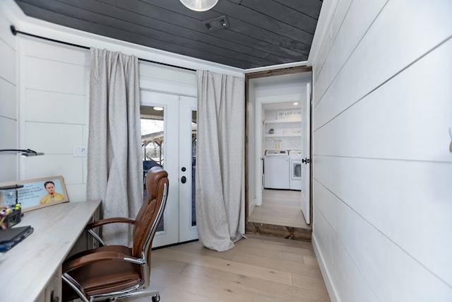 home office with wood ceiling, light hardwood / wood-style floors, washing machine and dryer, and french doors