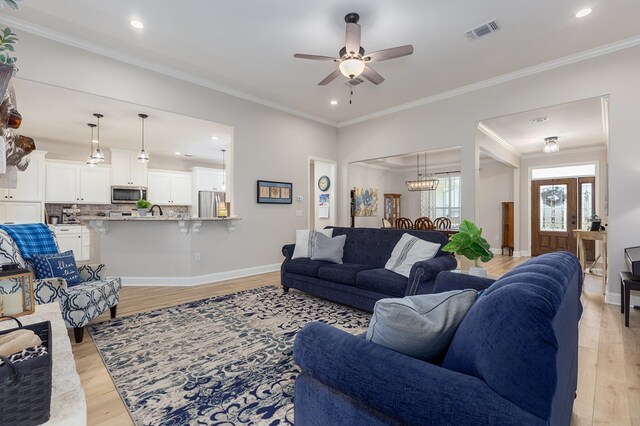 181 Rustic Pines Dr, Lufkin, TX 75904 - living room with light wood-style flooring, a ceiling fan, recessed lighting, ornamental molding, and baseboards