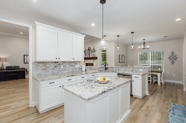 181 Rustic Pines Dr, Lufkin, TX 75904 - kitchen with a peninsula, light wood finished floors, white cabinets, a sink, and recessed lighting
