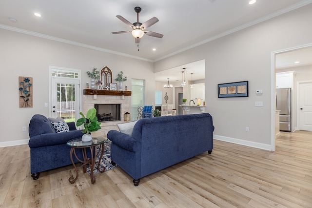 181 Rustic Pines Dr, Lufkin, TX 75904 - living area featuring a ceiling fan, light wood finished floors, baseboards, ornamental molding, and a stone fireplace