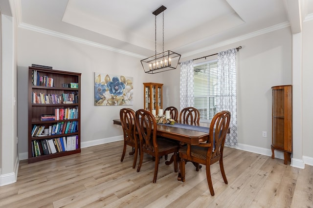 181 Rustic Pines Dr, Lufkin, TX 75904 - dining room featuring a tray ceiling, light wood-style flooring, baseboards, and crown molding