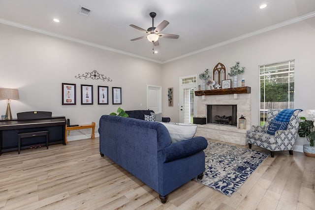181 Rustic Pines Dr, Lufkin, TX 75904 - living room with ceiling fan, wood finished floors, a stone fireplace, crown molding, and recessed lighting