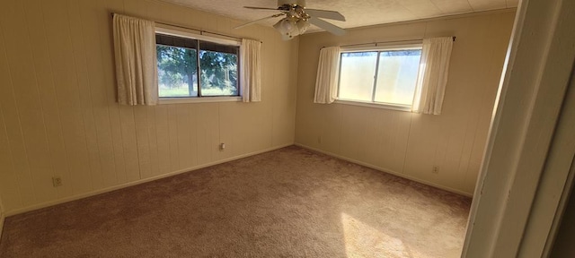 unfurnished room featuring ceiling fan and light carpet