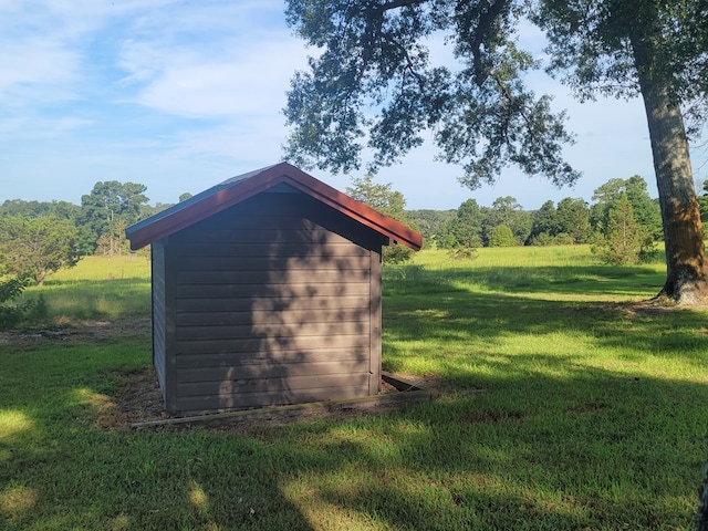 view of outbuilding featuring a yard