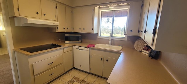 kitchen featuring dishwasher, black electric stovetop, sink, light tile patterned floors, and white cabinetry