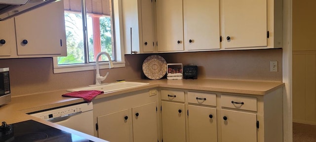 kitchen featuring dishwasher, white cabinetry, a wealth of natural light, and sink